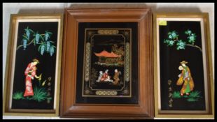 A group of three 20th Century Japanese black lacquer type panels. A pair hand painted on glass