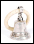 An early 20th Century silver hallmarked childs rattle in the form of a bell on a teething ring.