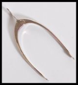 A hallmarked silver early 20th century novelty pair of sugar tongs / nips in the form of a wishbone.