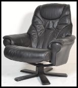 A retro 20th Century style black leather reclining swivel easy chair in the manner of Ekornes, the