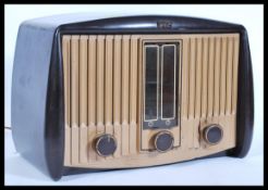 A vintage 20th Century bakelite valve radio by G E C, bakelite knobs and display to the front, Model