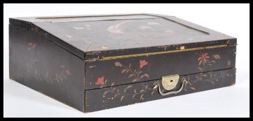 An early 20th century Japanese lacquered writing slope having chinoiserie decoration with birds of