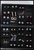 A collection of 30 contemporary designer sterling silver pairs of earrings to include cluster,