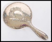 An early 20th Century hallmarked silver mirror having a central bevelled glass circular panel with