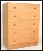 A mid century retro Meredew light oak chest of drawers. Raised on an inset plinth base with