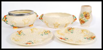 A collection of Clarice Cliff ' Celtic Harvest ' ware to include a fruit bowl,a white metal rim