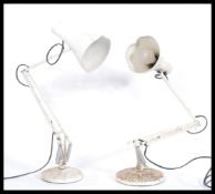 A pair of vintage retro 20th century Anglepoise industrial desk work lamps raised on circular