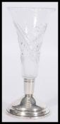 A vintage 20th Century silver hallmarked based cut glass vase raised on a stepped circular base with