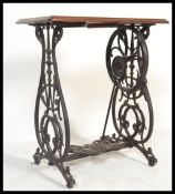 A 19th century  Victorian mahogany and cast iron Singer sewing machine table with decorative cast