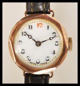 A hallmarked 9ct gold wrist watch having a white enamel face with gilt surrounded chapter ring and