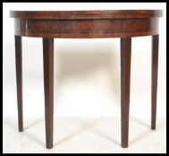 A 19th century mahogany string inlaid demi - lune fold over card / games table  with green baize
