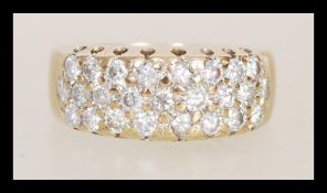 A hallmarked 9ct gold diamond ring having three rows of brilliant cut diamonds. Diamonds total