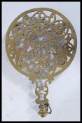 A 19th Century Masonic interest cast brass trivet, the scroll work base incorporating masonic