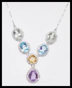 A stamped 925 silver pendant necklace having a collar of amethyst, citrine, and blue topaz having