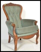 A 20th Century Georgian revival walnut framed fireside spoon back armchair, upholstered with