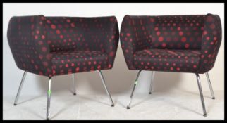 A pair of retro style tub armchairs by Sven Christiansen, the chairs raised on chrome tubular