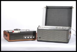 A vintage 20th Century portable two tone record player having a fitted four speed Garrard record