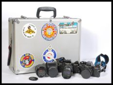 A pair of vintage Praktica 35mm BCA Electronic photographic cameras,with a selection of lenses and