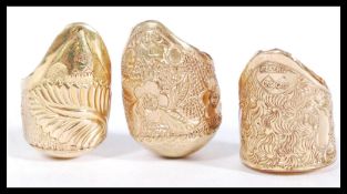 Three marked 18ct gold plated walking stick collars having engraved foliate and floral decoration.