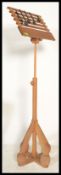 A 20th Century pine  music / lectern stand, the adjustable central  pole supported on a turned