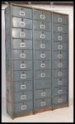 A large Industrial mid century 30 section fall front filing cabinet of metal construction having