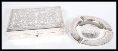 A vintage early 20th century Persian silver cigarette box along with a matching ashtray. Decorated