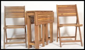 A teak drop leaf garden /patio table of small proportions together with a pair of matching teak