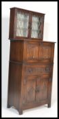 A Jaycee / Old Charm jacobean revival drinks / cocktail display cabinet. The hinged top with