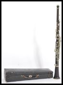 A 20th Century ebonised clarinet having white metal fittings within its original velvet lined and