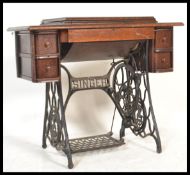 A Victorian oak and cast iron Singer Sewing machine and treadle table. The decorative cast iron