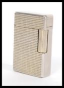 A vintage 20th Century Dupont of Paris white metal pocket lighter having a grid square design.