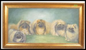 A 20th Century oil painting of five Pekingese dogs in front of a blue back ground within a gilt