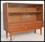 A retro 1970's teak wood glazed display cabinet having a pair of smoked glass sliding doors above