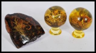 A group of unusual taxidermy scorpions preserved in faux amber lucite consisting of two balls on