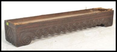 An 18th century carved West country oak long footstool. The carved oak planked rectangular base with