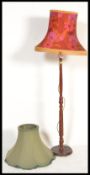 A vintage retro standard lamp having a wooden reeded stand with a 1960's retro shade white a red and