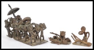 A selection of West African Ashanti tribal figurines including a large group scene depicting a