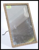 A 19th century bronze wall mirror / easel mirror. The shaped bronze frame with central mirror glass,