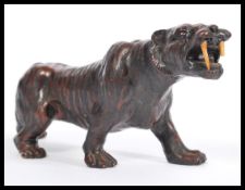 A composite figurine / ornament of a stalking sabre toothed tiger having engraved detailing with