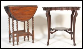 A Victorian mahogany Art Nouveau centre table raised on sabre style legs with undertier together