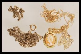 A selection of 9ct gold necklaces to include a stamped 9ct filigree butterfly pendant necklace, a