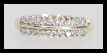A 9k 9ct gold ring set with two rows of diamonds. Diamond of approx 25pts. Weighs 1.8 grams size O.