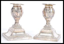 A pair of 19th century Victorian silver hallmarked candlesticks raised on gadrooned square bases