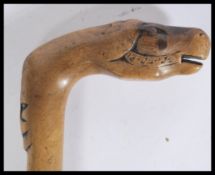 A vintage early 20th Century carved Crete walking stick cane having a tapering wooden shaft with