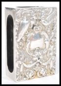 A 20th Century silver hallmarked over sized matchbox holder having embossed decoration to the