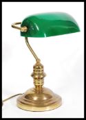 A vintage retro 20th century gilt brass bankers lamp raised on a circular base with adjustable green
