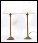 A pair of 20th Century matching brass column table lamps, of Corinthian column form raised on a