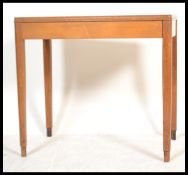 A mid 20th century century beech wood Air Ministry type writing table desk being raised on square