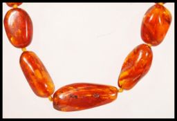 A 20th Century amber graduating beaded necklace set with a gilt lobster clasp.