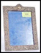 A hallmarked early 20th century silver hallmarked easel back picture frame having Rococo influence